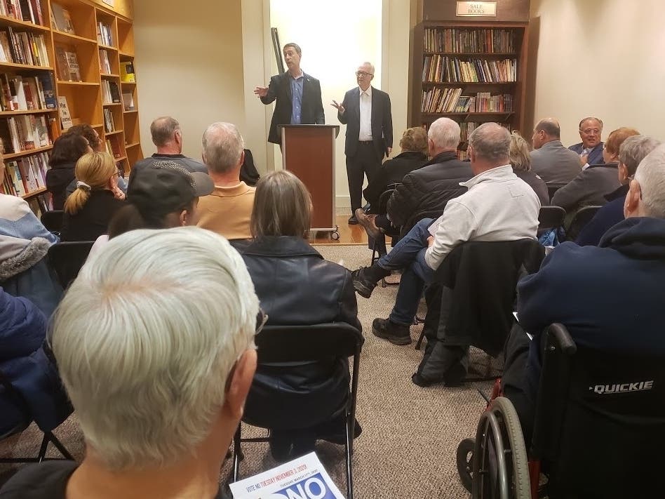 Burr Ridge Trustee Zach Mottl, left, and Jim Tobin, president of the Chicago-based Taxpayers United of America, lead a meeting of opponents to home rule in the village. Mayor Gary Grasso can be seen to the right in the front looking back. 