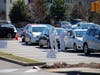 Doctors in hazmat suits are seen attending to long lines of cars with people waiting to get tested for the coronaviru last week in Waltham, Mass.