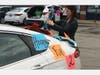 Kristyn Hegner of Chicago decorates her car in Elmhurst on Tuesday for a parade in honor of 2-year-old Clara Thommes, who was celebrating her birthday. 