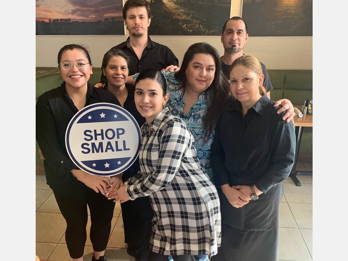 Prasino co-owner Peggy Maglaris Kopley (in turquoise) and employees pose for a photo at the restaurant recently. 