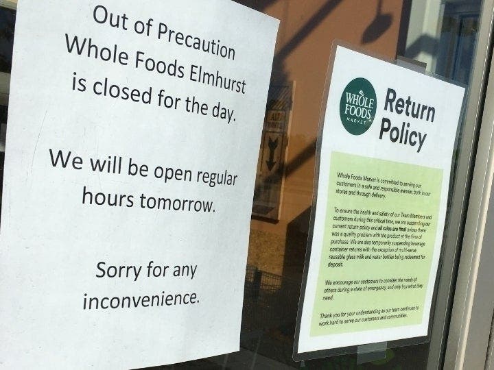 A sign on Whole Foods' door Sunday says it is closed for the day "out of precaution."