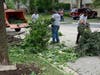 Men put branches into a wood chipper late Monday morning on Darien's Woodmere Drive. 