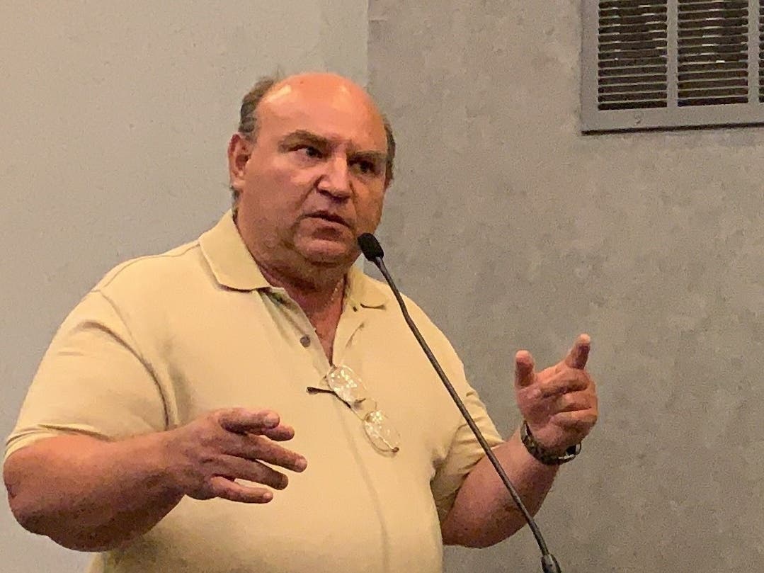 John Dulles, owner of Dulles Cleaners, alleged that Fitness Formula Clubs members dominated the parking on Addison Avenue, hurting other businesses. He spoke beyond his allotted time. 