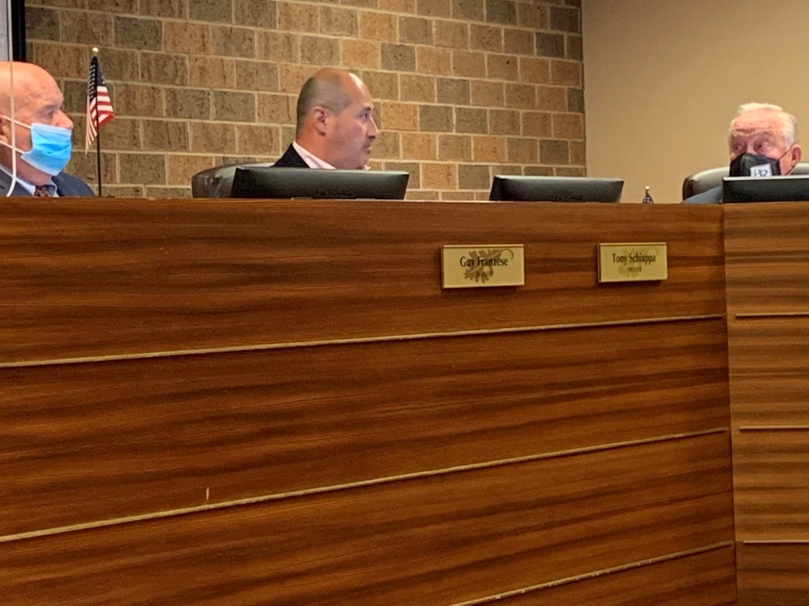 Burr Ridge Trustee Tony Schiappa (center) speaks at a Village Board meeting last week. He attended a secret meeting of the majority in 2018. Trustee Guy Franzese (left) and Al Paveza were among those uninvited.