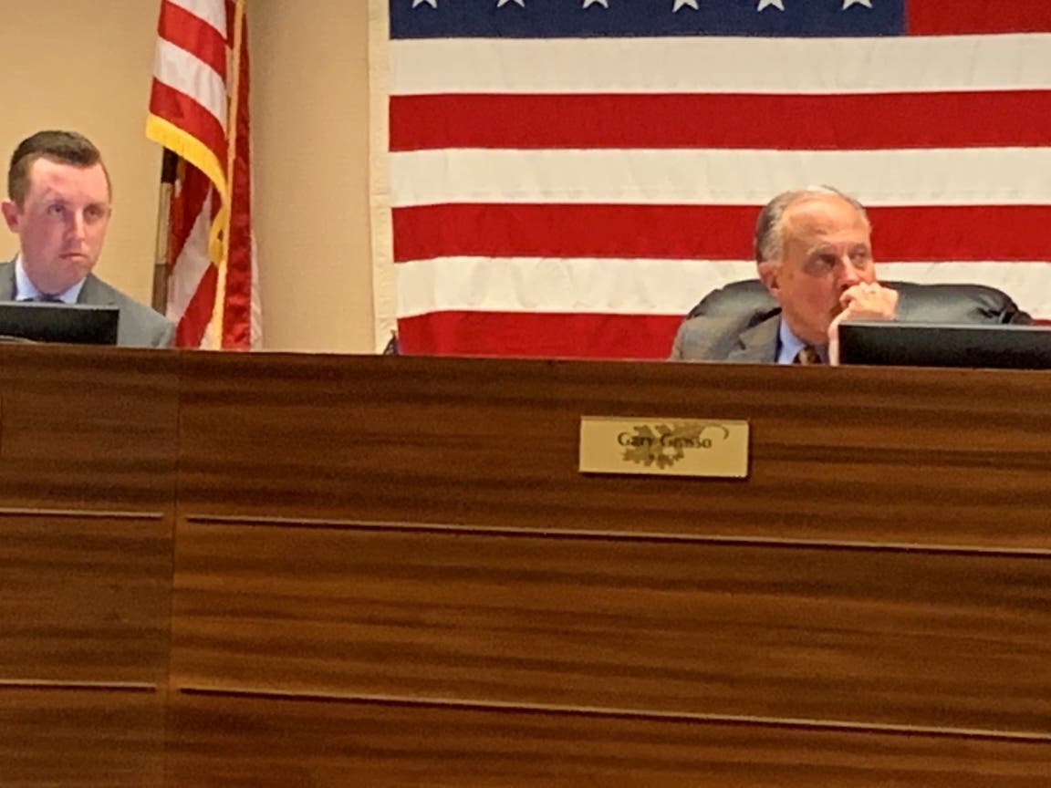 Burr Ridge Mayor Gary Grasso (right) made a point about Burr Ridge's property taxes at Monday's Village Board meeting. Next to him is Village Administrator Evan Walter. 