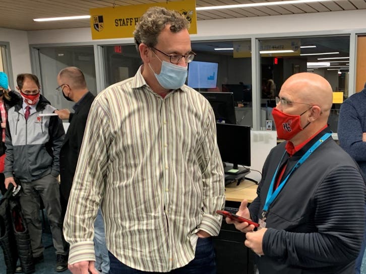 Jeff Waters (left), a Hinsdale High School District 86 board member, speaks with Hinsdale Central's athletic director, Dan Jones, before Thursday's board meeting. 