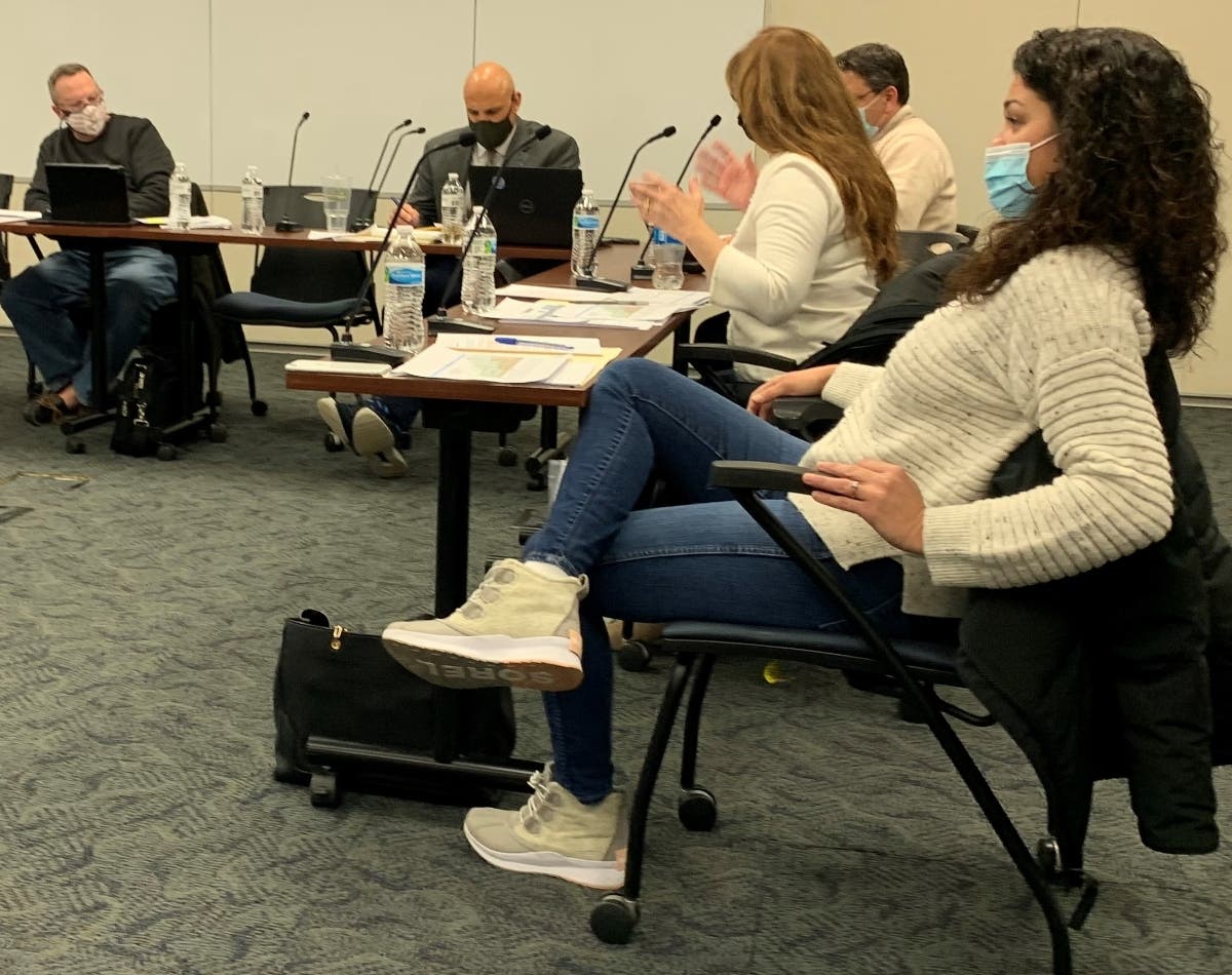 Athena Arvanitis (foreground), a board member for Elmhurst School District 205, disagreed with her colleagues, Jim Collins (left), and Karen Stuefen (next to Arvanitis) over a policy on how much money that the district should keep in the bank.  