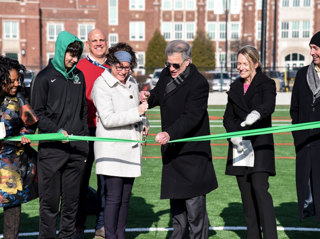 In the center, Elmhurst school board President Kara Caforio and Elmhurst Mayor Scott Levin ceremoniously cut the ribbon last week for the new stormwater vaults and artificial turf field at York High School. 