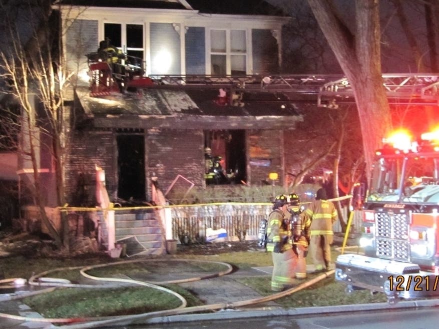 A Hinsdale Fire Department truck extends a ladder to the house at 241 S. Ashland Ave. early Tuesday evening. 