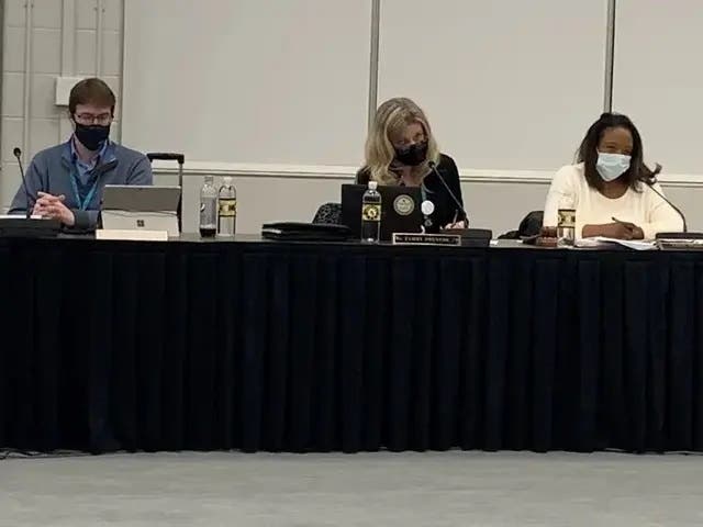 Tammy Prentiss (center), superintendent of Hinsdale High School District 86, listens to public comments last week. Many called for her firing. Next to here are board member Erik Held and board President Terri Walker.