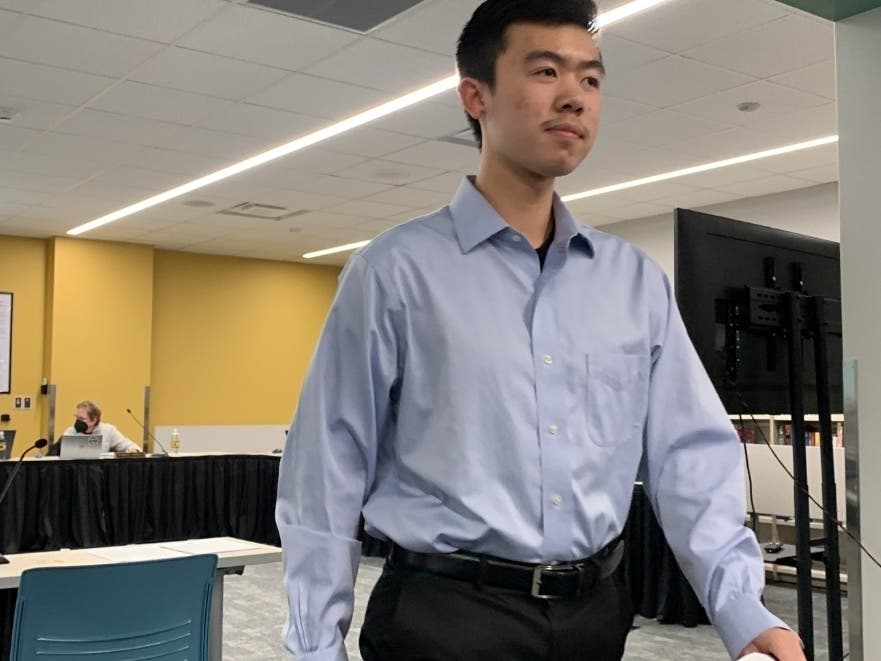 Ethan Pan, a Hinsdale South High School student, walks away after speaking to the Hinsdale High School District 86 board Friday night. He said students opposed to the mask mandate were harassed for their views.