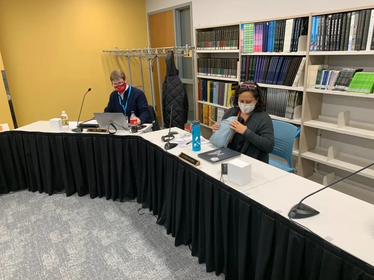 Erik Held (left), a Hinsdale High School District 86 board member, attends a board meeting in December. Next to him is member Cynthia Hanson. 