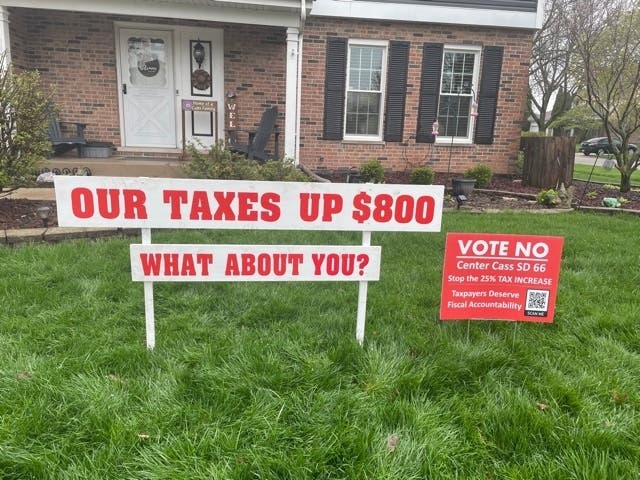 Signs against Center Cass School District 66's proposed tax increase are in front of Alderman Eric Gustafson's Darien house. 