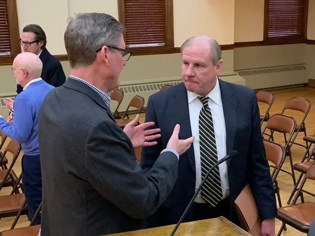 La Grange Village President Mark Kuchler (right) speaks with Village Clerk Paul Saladino before a Village Board meeting in April.