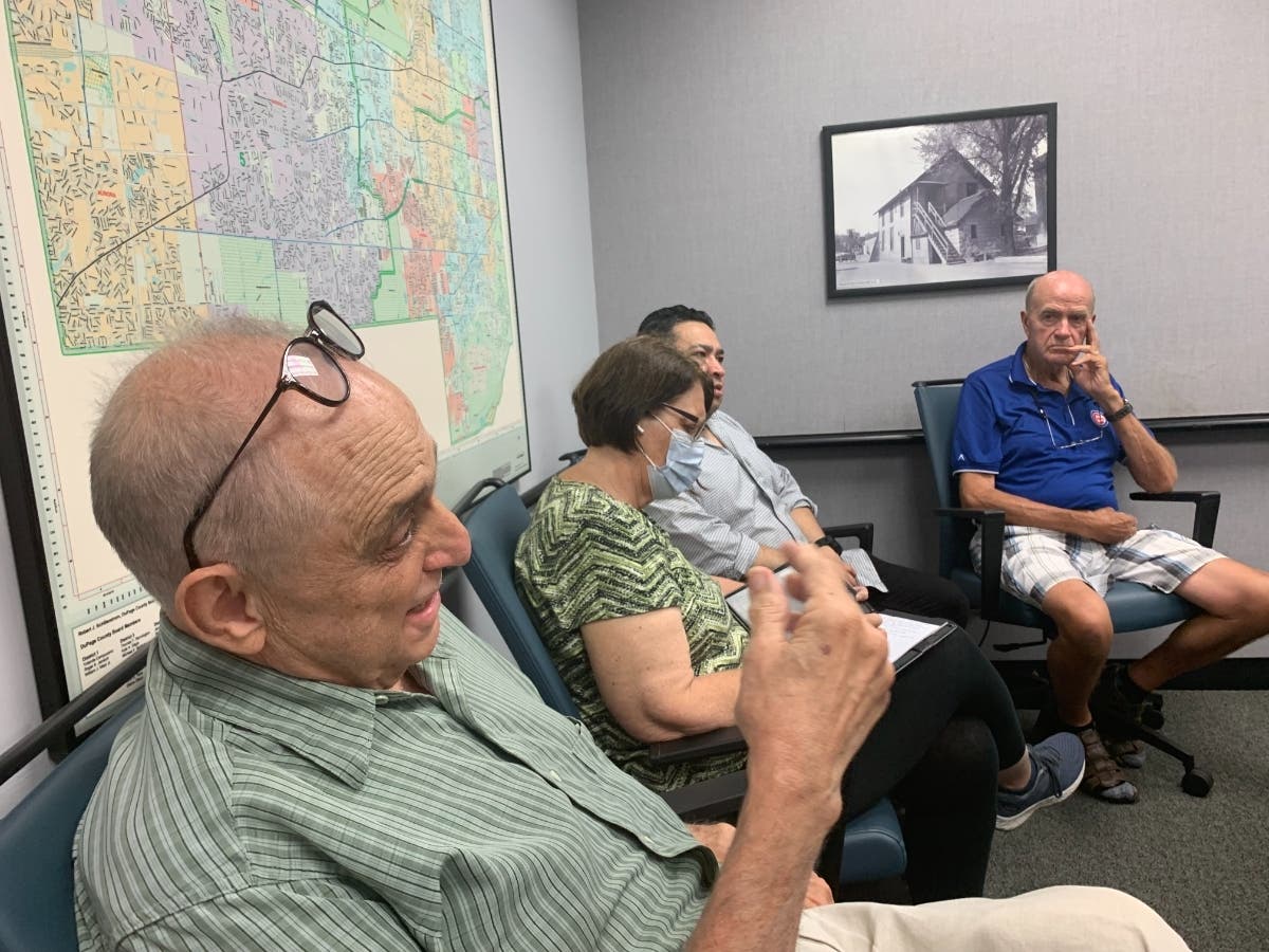 Paul Guerino (foreground), secretary of the Bensenville Fire District No. 1 board, spoke Monday to the City Council's Public Safety Committee. He warned about "lustful eyes" looking upon north Elmhurst. 