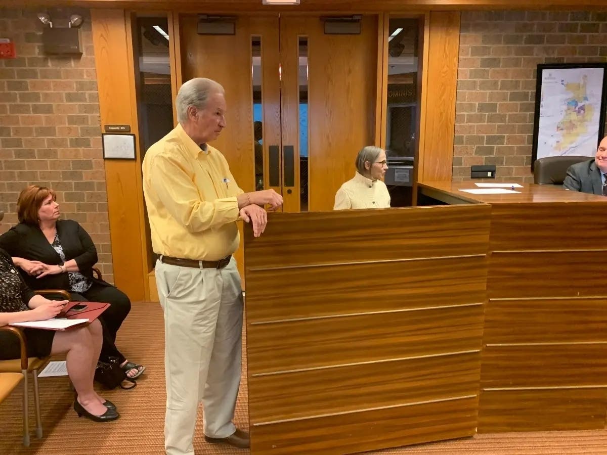 Developer Anthony Perino answers questions from the Burr Ridge Village Board in May about his proposed Cottages of Drew subdivision. To the right is resident Joanne Palmisano. 