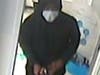 This suspect carried a large blue duffel bag during a robbery Monday at the AT&T store in Elmhurst, according to a police news release.