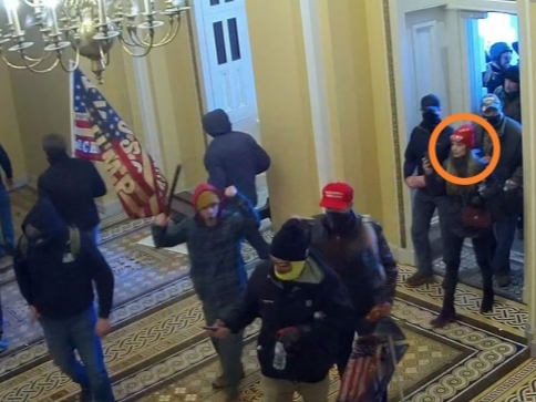 Leticia Ferreira of Indian Head Park is seen entering the U.S. Capitol on Jan. 6. In front of her is a man who appears to be carrying a stick. 