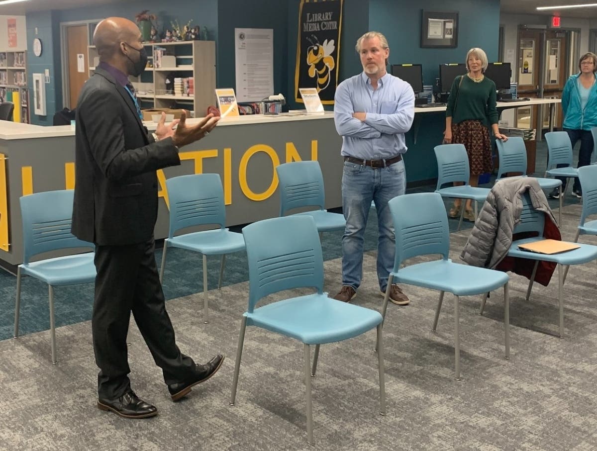 Hinsdale resident Andrew Catton listens as Hinsdale South Principal Patrick Hardy gives a tour of the campus during a school board meeting Thursday. Later that evening, Catton announced his candidacy for the school board. 