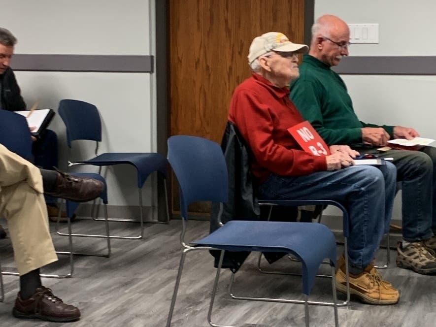 A man on Wednesday holds a sign reading "No R-3," which refers to the zoning designation for a proposed duplex development in Darien. He was attending a meeting of a Darien City Council committee, which approved the subdivision. 