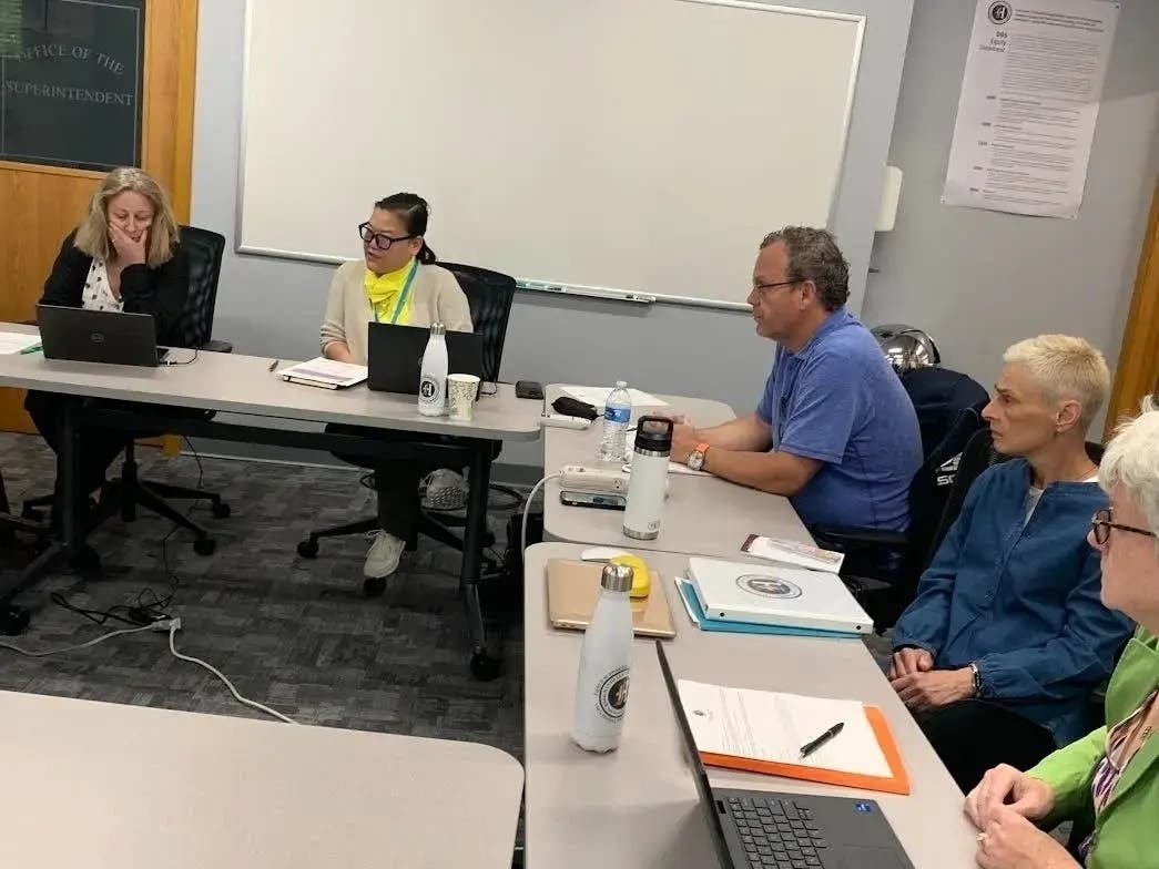 Catherine Greenspon (second from left), president of the Hinsdale High School District 86 board, presides over a summer meeting. Next to her (from left) are Peggy James, Jeff Waters, Debbie Levinthal and Kay Gallo. Gallo and Levinthal later resigned.