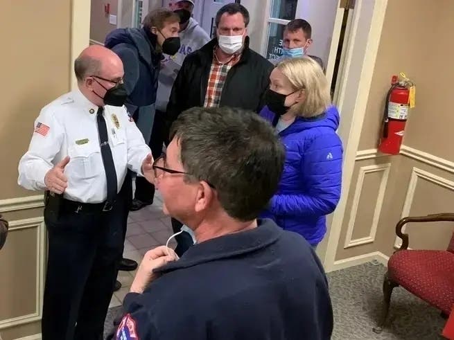 Clarendon Hills Fire Chief Brian Leahy (in white shirt) talks with residents during a February 2022 closed session of the Village Board. Mask mandates were in effect at the time.