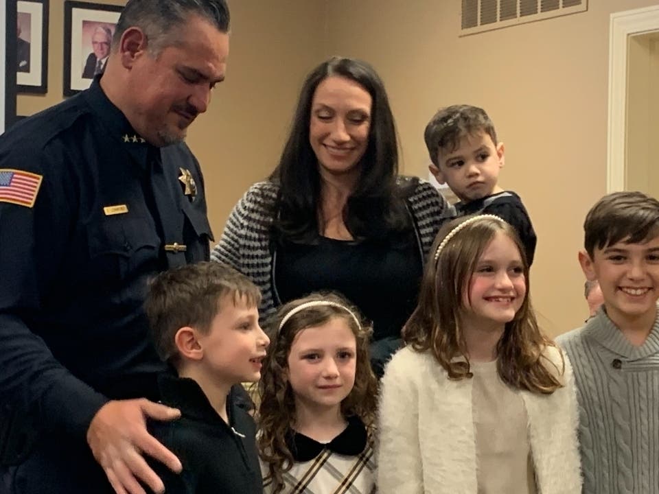 Clarendon Hills Police Chief Ed Leinweber is with his family after he was sworn in as the village's new chief. At that point, the Village Board had not voted on Leinweber's appointment, as the village code requires. 