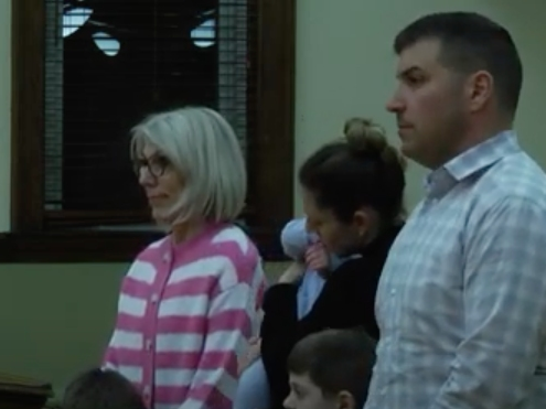 La Grange resident Kristopher Serra (foreground) worked to persuade the state to establish a school zone on Ogden Avenue in La Grange. The Village Board honored him Monday. He was with his family. 
