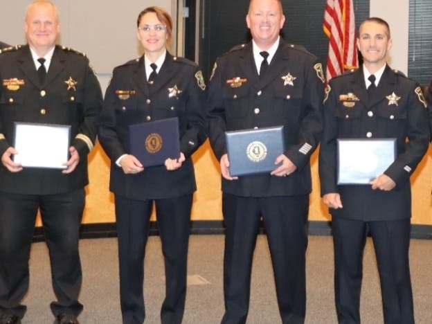 At Monday's Elmhurst City Council meeting, (from left) Deputy Police Chief James Gandy, Detective Joan Velez, Officer James O'Connor and Officer Michael Hamblin were honored. 
