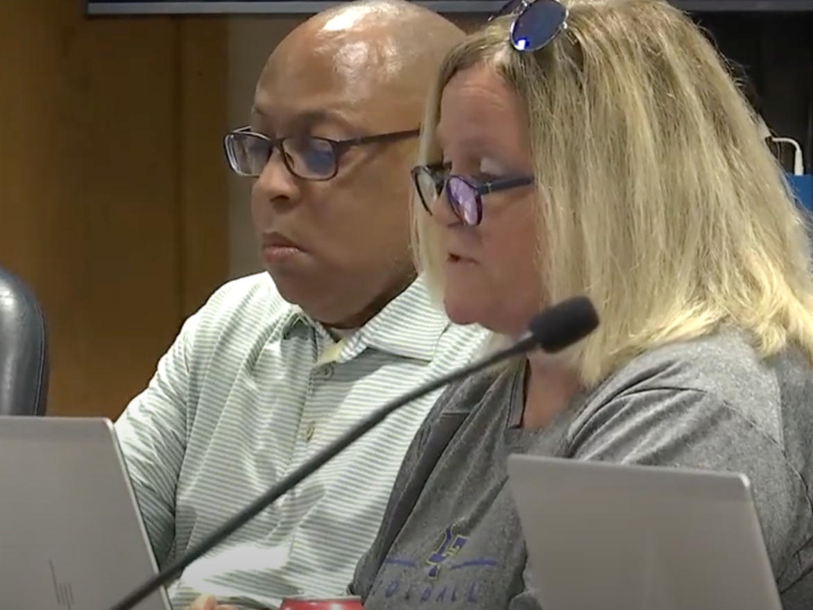 Paula Struwing, a Lyons Township High School board member, defends herself Monday against critics of her comments at a board meeting earlier this month. Next to her is member Michael Thomas. 