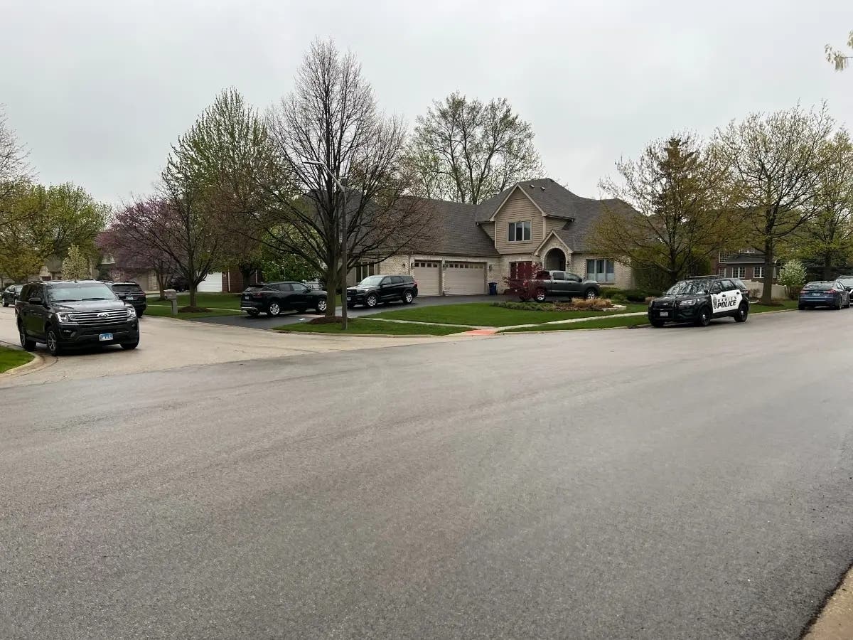 Unmarked federal agents' cars were outside a house in the 900 block of Windmere Court in Darien in April 2023. An assistant girls track coach at Downers Grove South High School was arrested. 