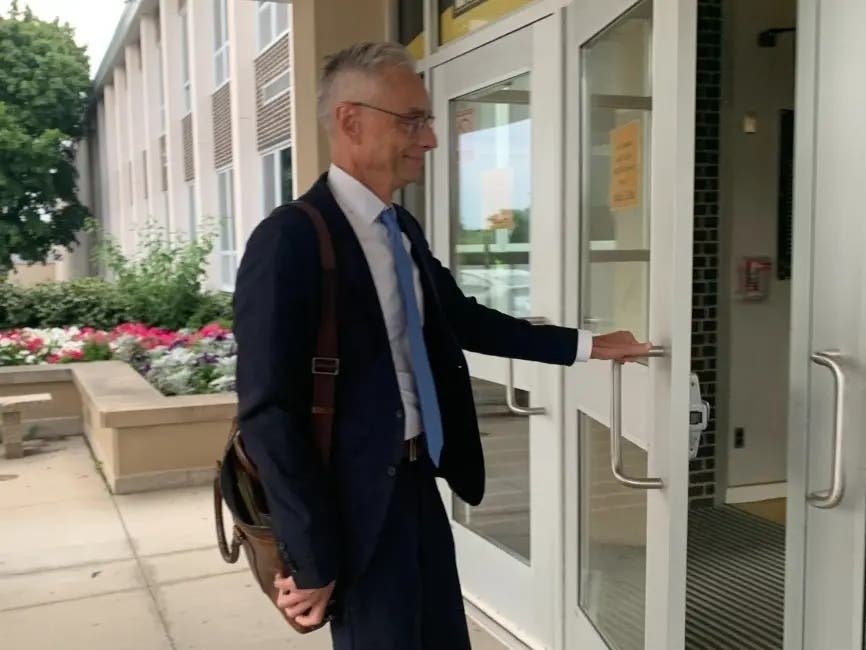 Joseph Perkoski, an attorney with Robbins Schwartz, enters Hinsdale South High School for a closed school board session in June. 
