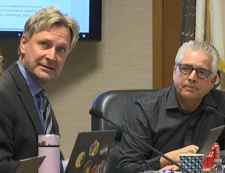 Brian Stachacz (left), Lyons Township High School's top finance official, reported a $3.1 million surplus last budget year. Next to him is board member Elias Lopez. 