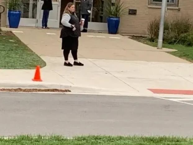 Sheleen DeLockery, principal of Emerson Elementary in Elmhurst, stands outside one of the school's entrances in November 2021 during an anti-face mask protest. A school district official warned a Patch reporter against approaching her for an interview.