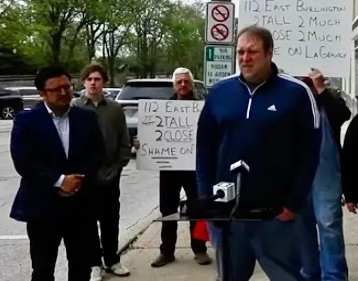 La Grange resident Jonathan Robinson last month criticized the village's handling of the local Jackson Square building. To the left is Byron Sigcho Lopez, who is running for Congress. 