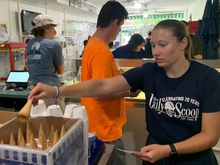 Hayden Bos works behind the counter in July 2024 at the Daily Scoop ice cream shop in Clarendon Hills. The shop closed not long afterward.
