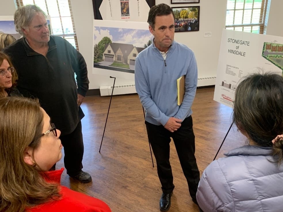 John Barry, vice president of McNaughton Development, listens to residents Thursday at an open house about a proposed Hinsdale development at The Community House.