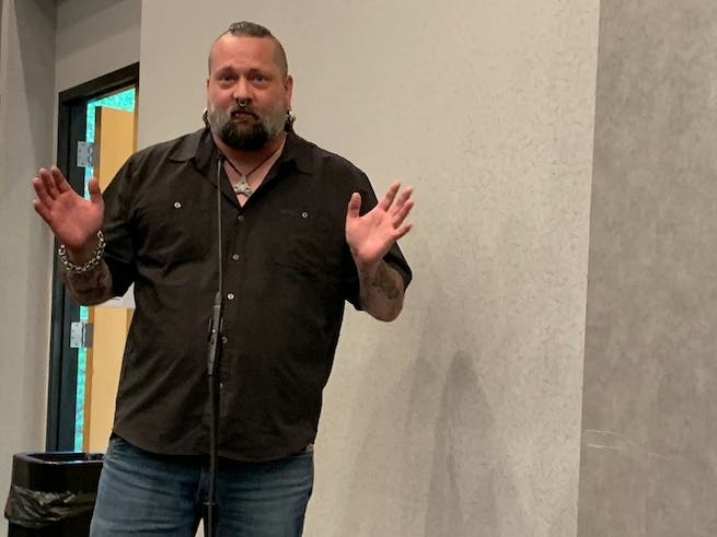 Lance Neilson, a tattoo artist in Bensenville, described one of Elmhurst's new tattoo shop rules as "irresponsible and dangerous." He spoke at Monday's Elmhurst City Council meeting.