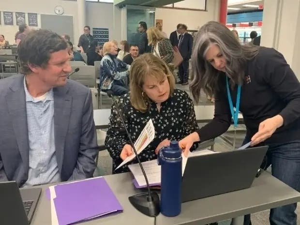 Liz Mitha (center), a Hinsdale High School District 86 board member, is with member Bobby Fischer and District 86 employee Deb Kedrowski at a meeting last year. 