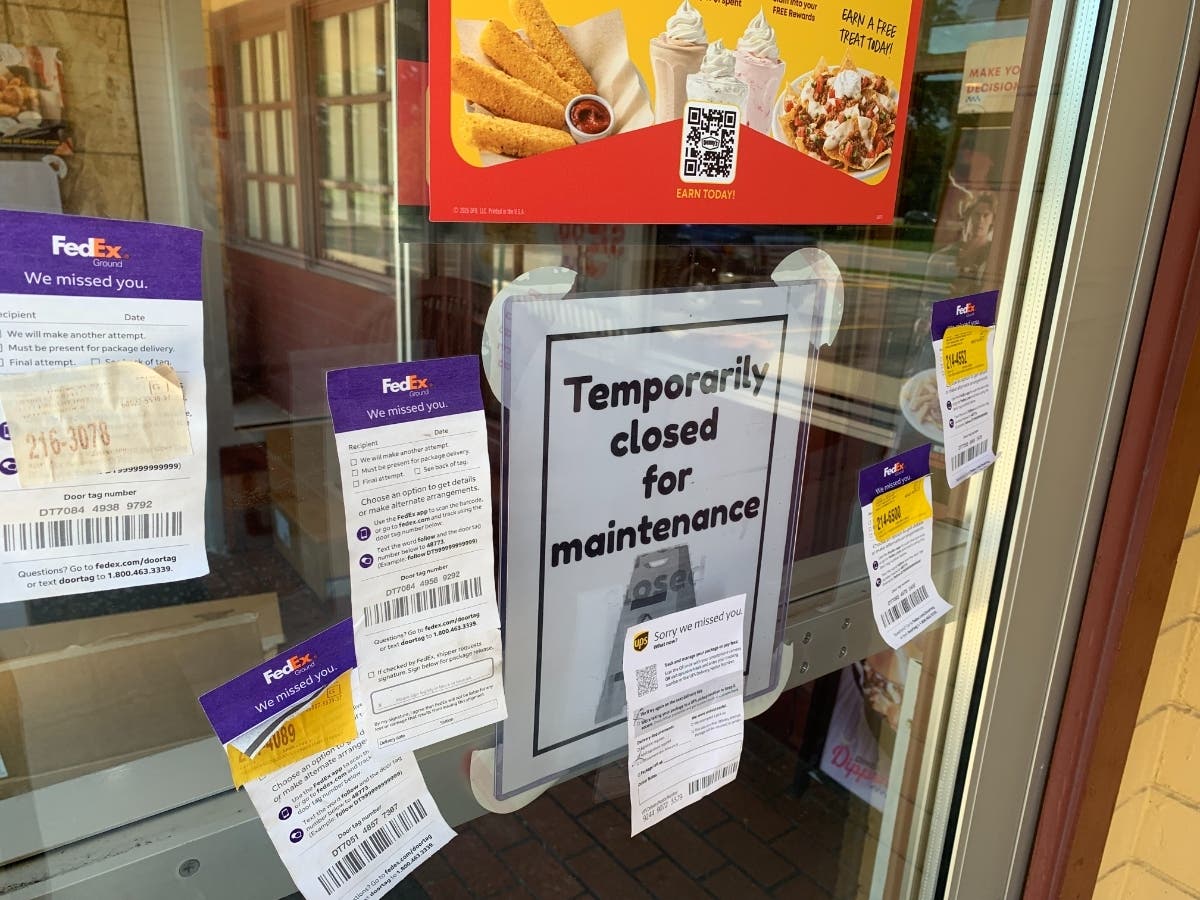 The front door of the Denny's in Willowbrook says it is "temporarily closed for maintenance." Shipping firms have left notices.