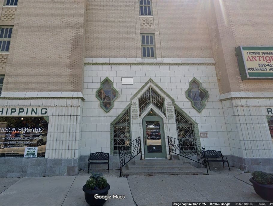 The demolition of La Grange's Jackson Square building has been delayed indefinitely. A neighbor's lawsuit is the stumbling block.