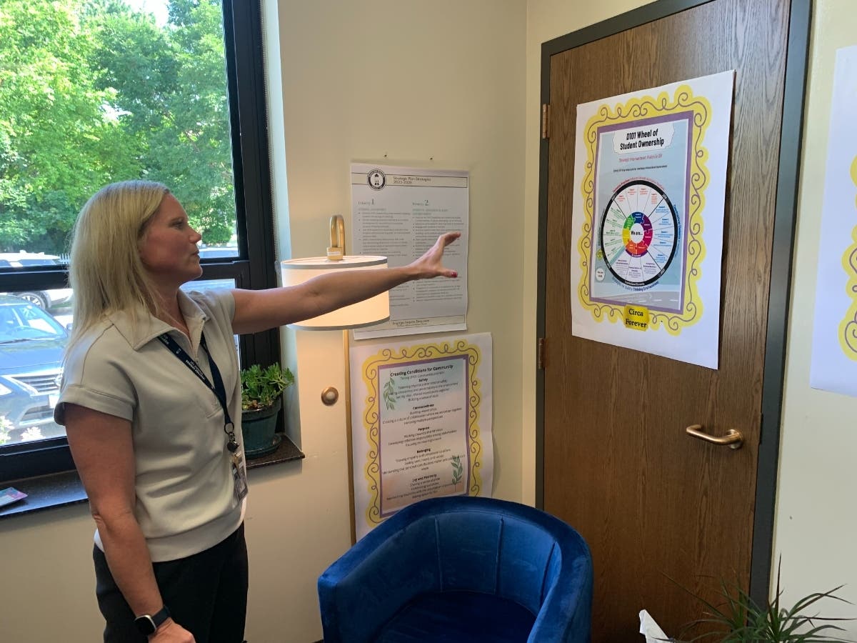 Sarah Coffey, superintendent of Western Springs School District 101, points to a poster about the district's strategies during a recent interview in her office. She was promoted to superintendent in 2024.