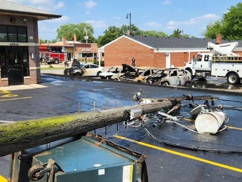 La Grange Park firefighters responded to four car fires at a local business after a utility pole fell Tuesday, officials said.