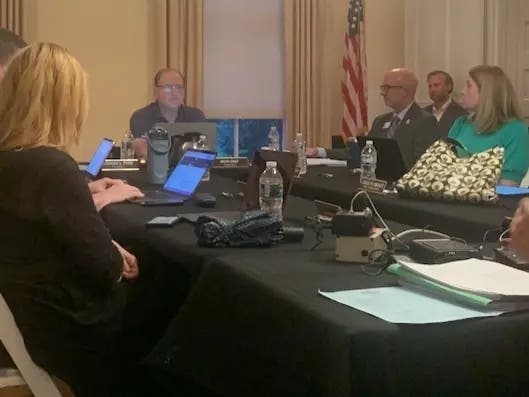 Kevin Graf, president of the Elmhurst Park District board, is at the head of the table at the Aug. 10 meeting. He was part of a board majority that rejected putting a question about a proposed bandshell's location on the November ballot.