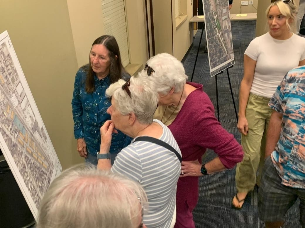 Residents on Monday look at plans for an 84-unit townhome development at Cossitt and Bluff avenues in La Grange.