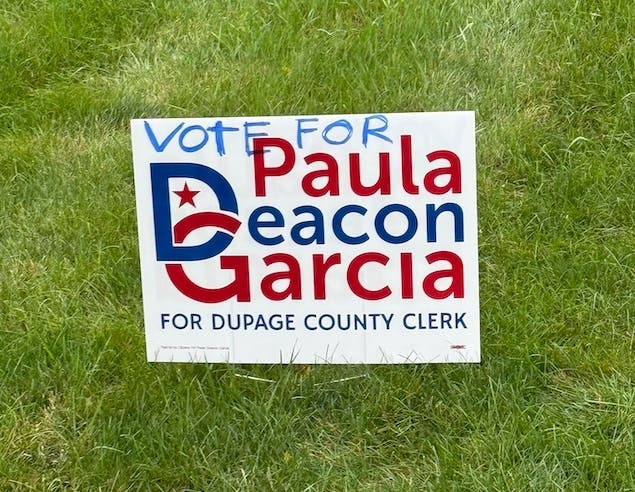 Burr Ridge warned a former village trustee, Zach Mottl, about a sign he posted for DuPage County clerk candidate Paula Deacon Garcia. The village's code bans identical signs. Mottl altered one of his with handwriting.