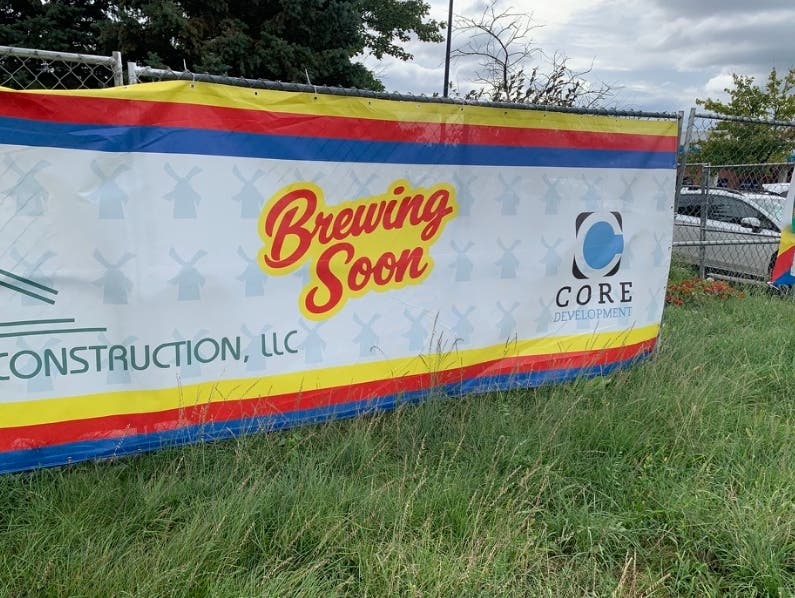 A sign on the old TGI Fridays site advertises a coming chain coffee shop. TGI Fridays was torn down to make way for a building containing Dutch Bros Coffee and Andy's Frozen Custard.
