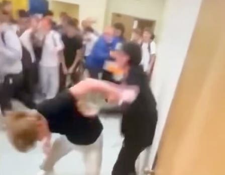 Students can be seen fighting in this screenshot from a video taken in the South Campus boys locker room. One student attacked another from behind.
