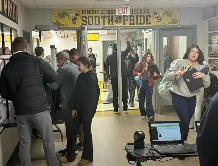 Hinsdale South High School students go through a weapons detection system in December 2024. Such screening started after a student was found with a loaded gun a few days before Thanksgiving.