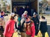 In the truck, Assistant Senior Patrol Leader Katie Cannon (L) and Patrol Leader Keira Lowden (R) are receiving donations from Troop 19